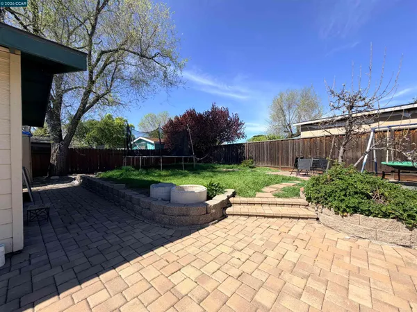 a view of a backyard with plants and brick walls