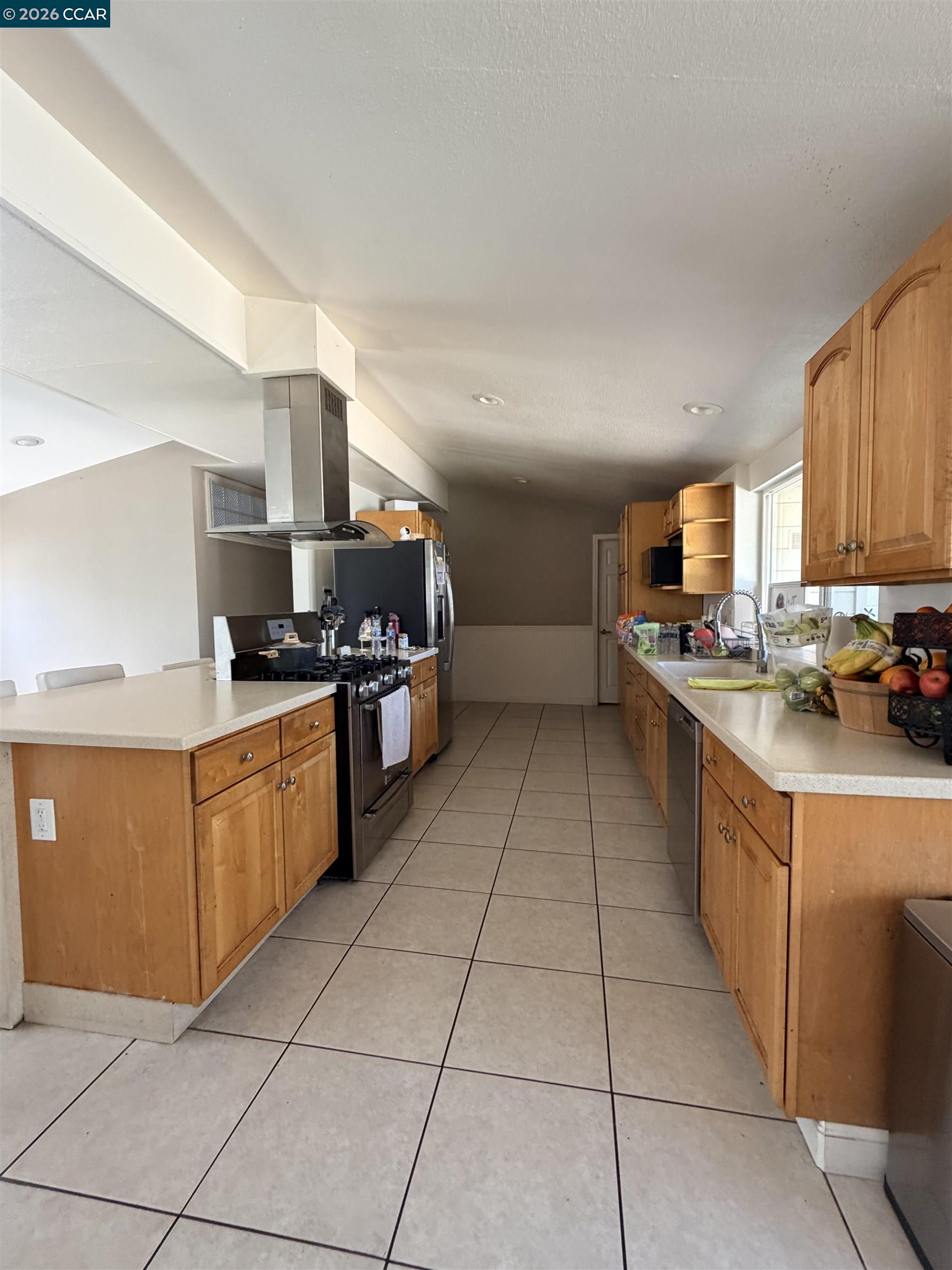 3355 Bennett Way Concord, CA 94519 - Photo 3 of 3 a kitchen with stainless steel appliances granite countertop a sink counter space cabinets and a view of living room