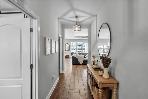 a living room with furniture a flat screen tv and a potted plant
