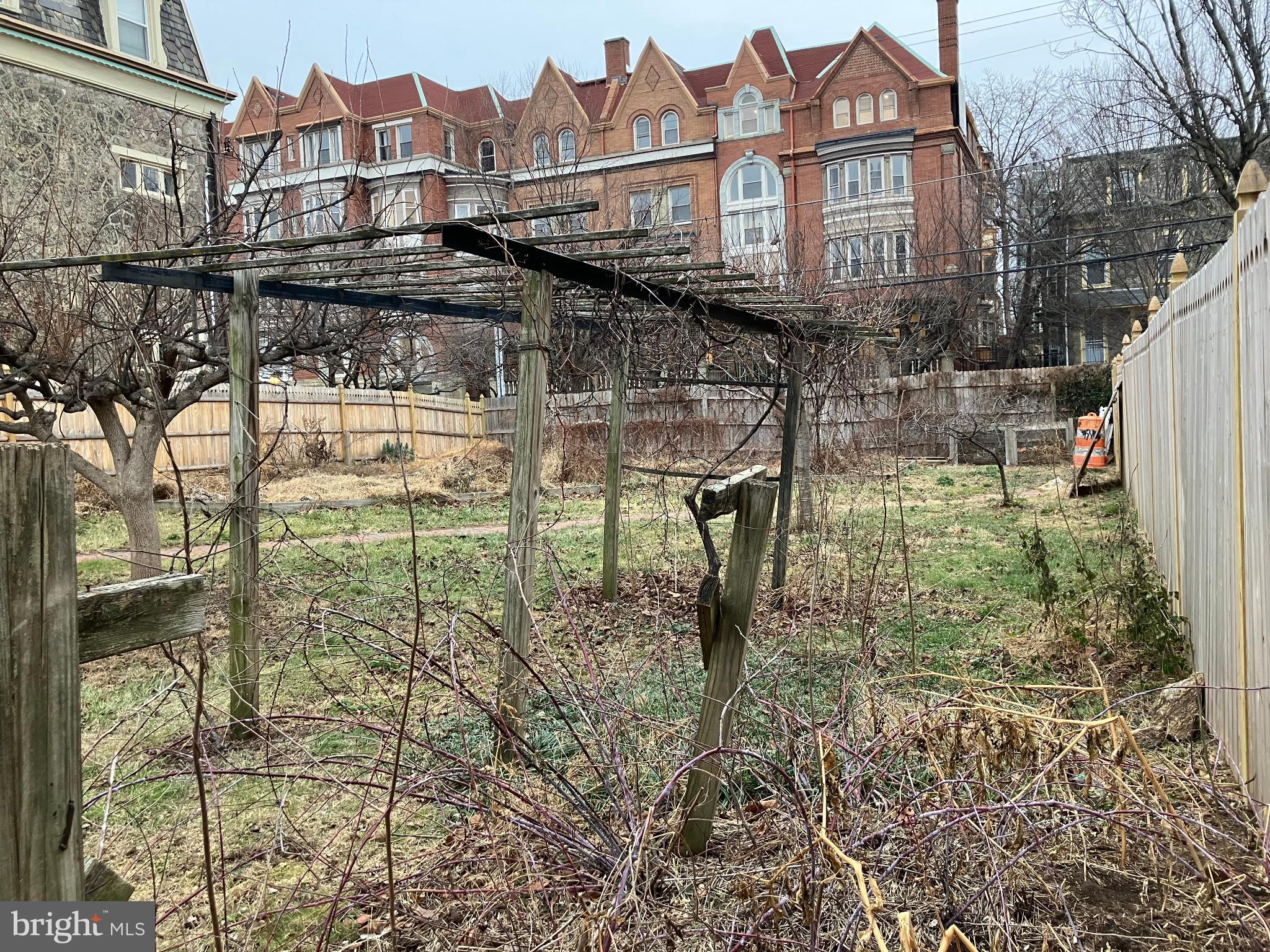204 North 36th Street Philadelphia, PA 19104 - Photo 3 of 9 Overgrown garden with historic backdrop.