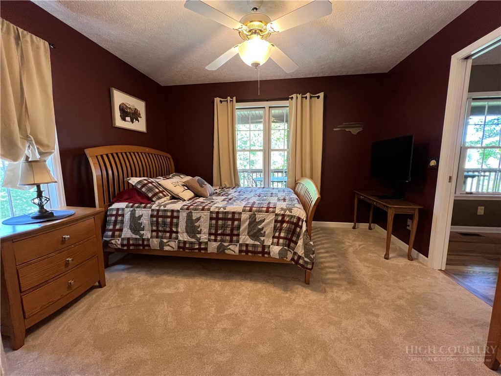 139 New River Ridge Estates Laurel Springs, NC 28644 - Photo 19 of 34 a bedroom with a bed and a flat screen tv