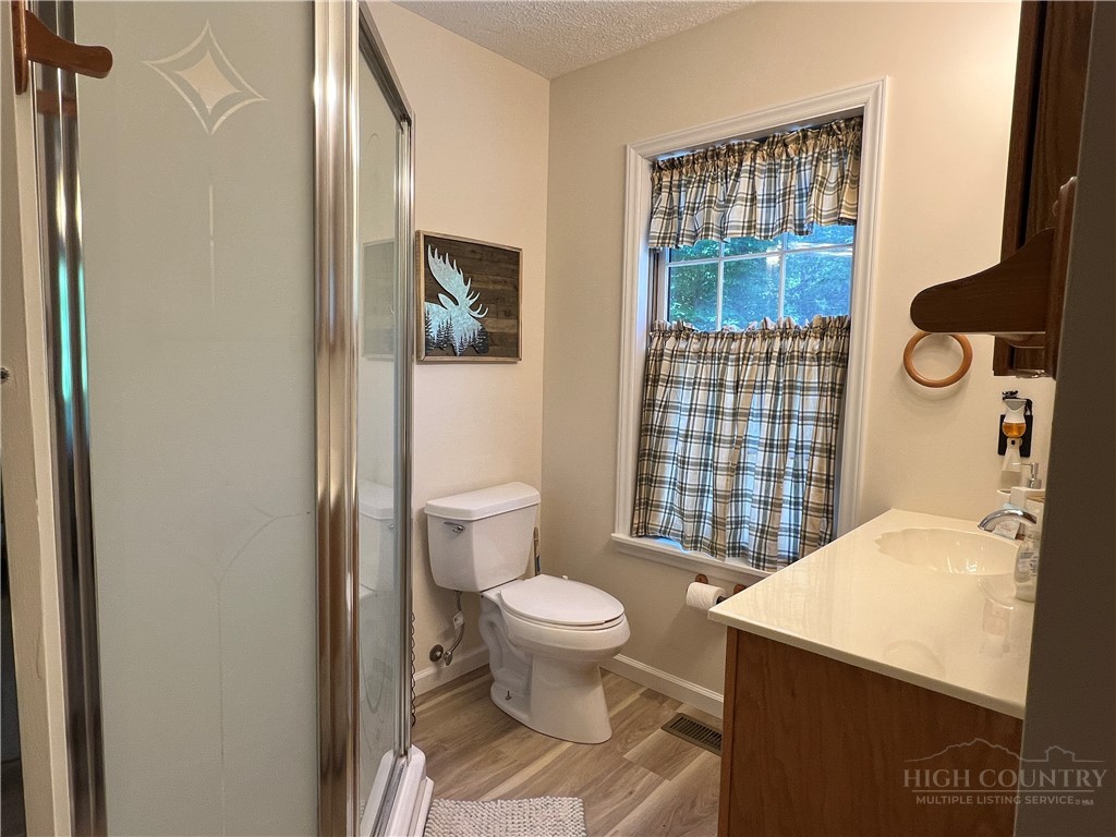 139 New River Ridge Estates Laurel Springs, NC 28644 - Photo 23 of 34 a bathroom with a sink toilet and shower