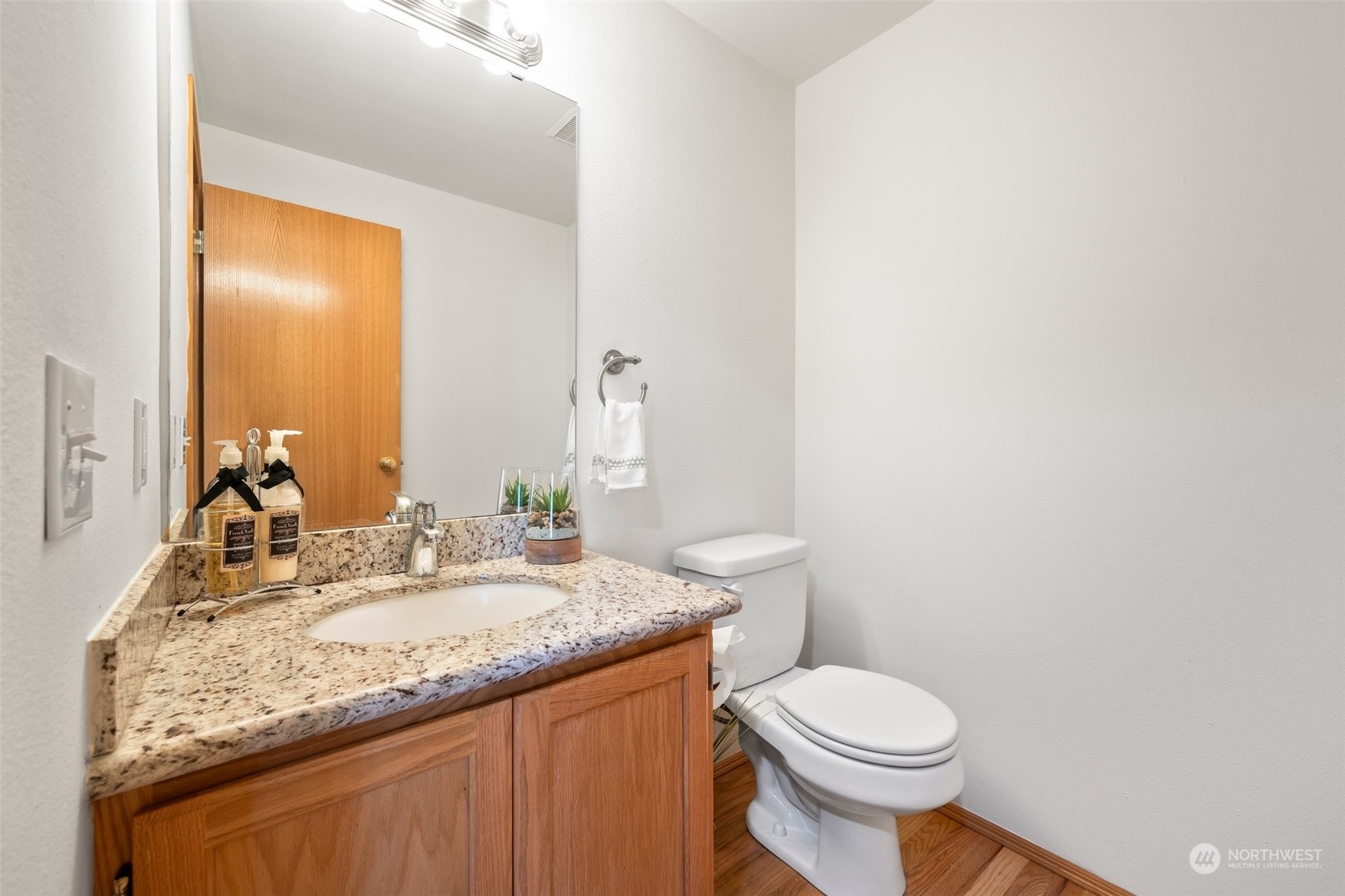 4318 Northeast 2nd Court Renton, WA 98059 - Photo 12 of 29 a bathroom with a granite countertop sink a toilet and a mirror