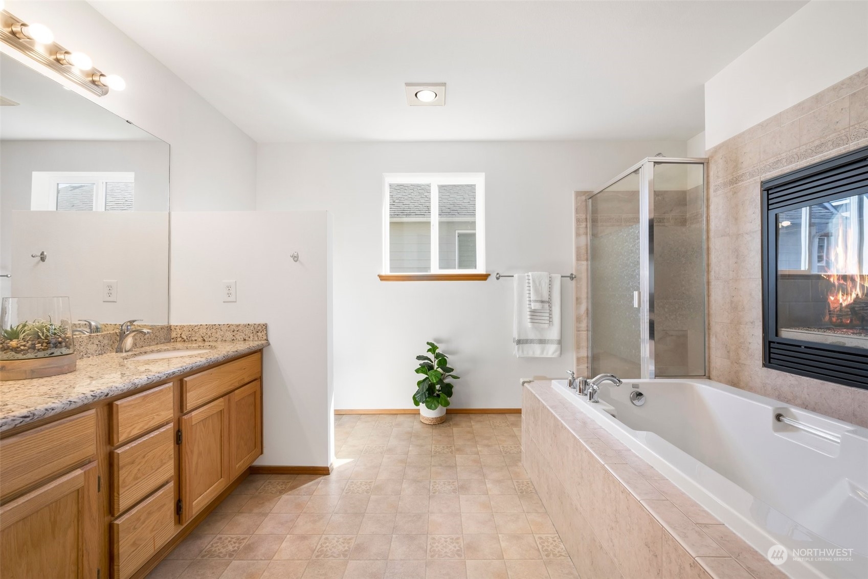 4318 Northeast 2nd Court Renton, WA 98059 - Photo 18 of 29 a spacious bathroom with a granite countertop tub sink and mirror