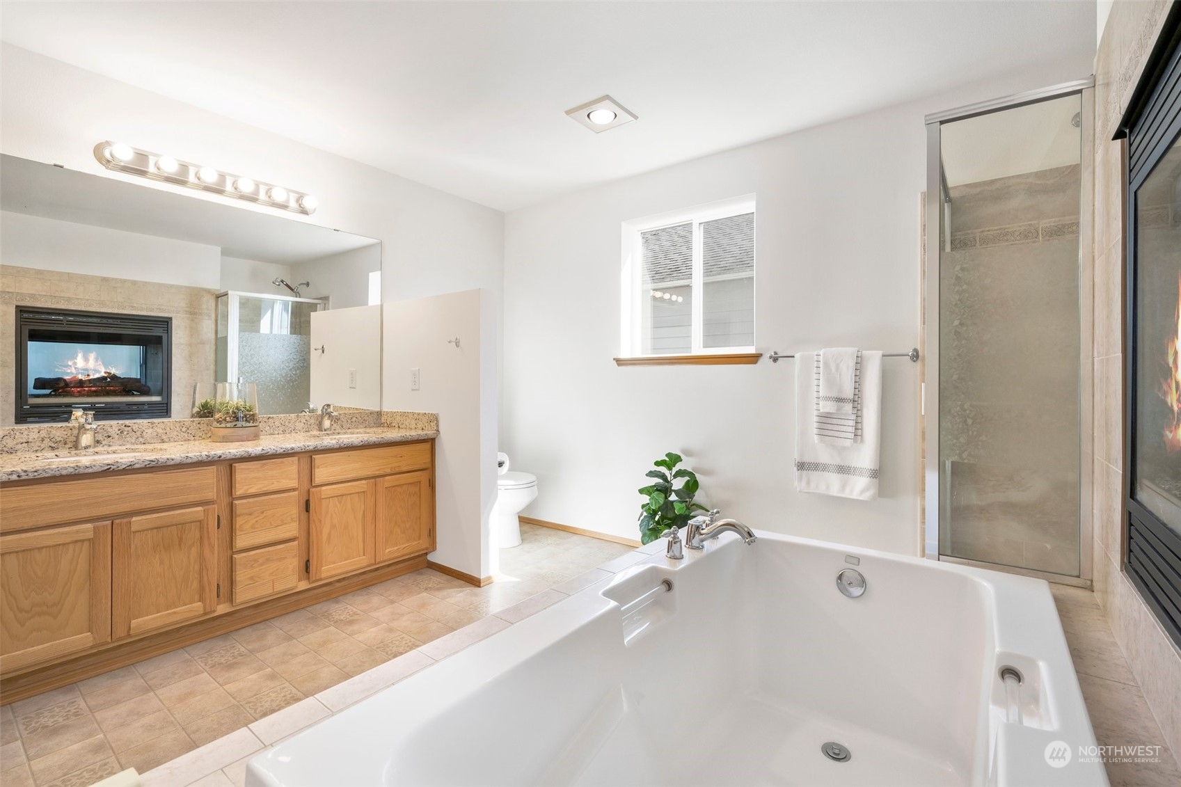 4318 Northeast 2nd Court Renton, WA 98059 - Photo 19 of 29 a spacious bathroom with a tub sink and mirror
