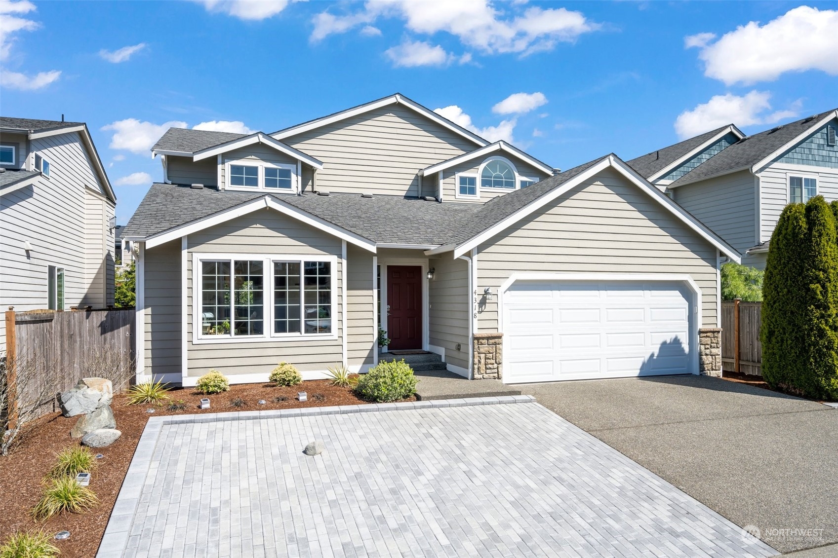 4318 Northeast 2nd Court Renton, WA 98059 - Photo 25 of 29 a front view of a house with a yard and garage