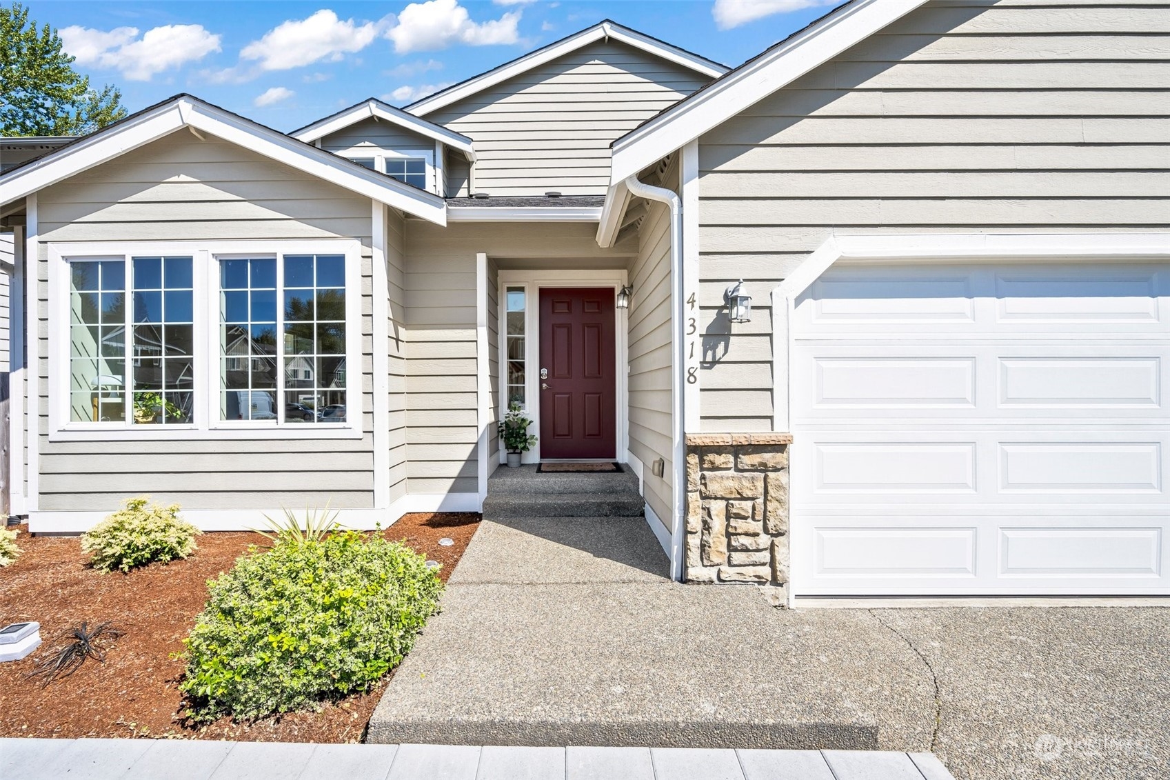 4318 Northeast 2nd Court Renton, WA 98059 - Photo 27 of 29 a front view of a house with a yard and garage