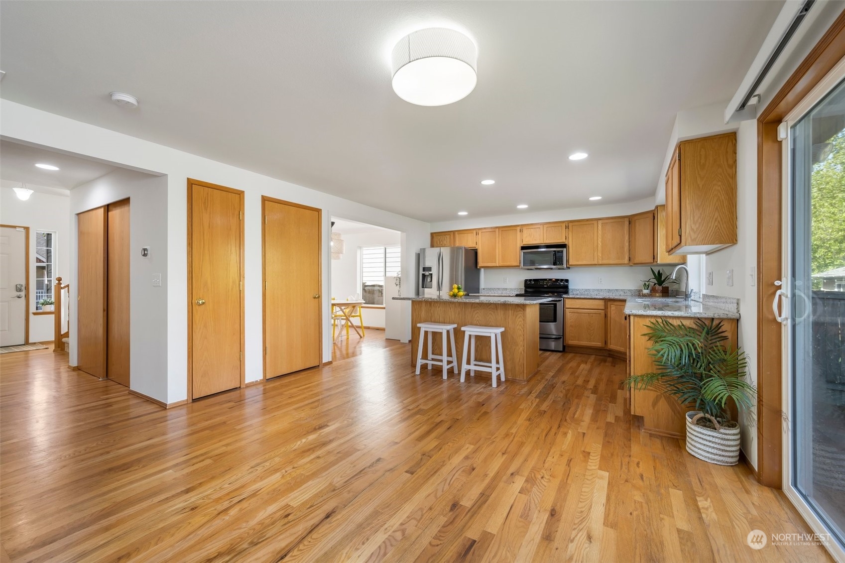 4318 Northeast 2nd Court Renton, WA 98059 - Photo 4 of 29 a open kitchen with a table and chairs