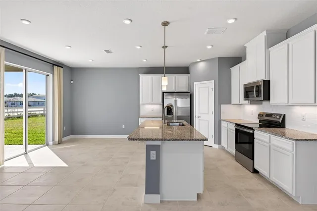 an empty room with a cabinet and mirrors