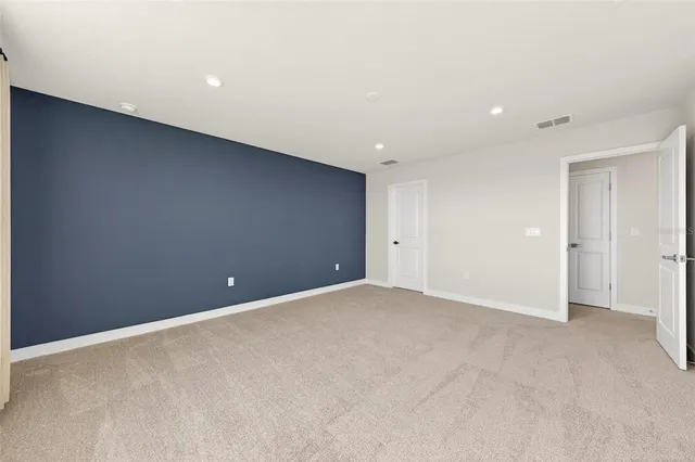 an empty room with windows and closet