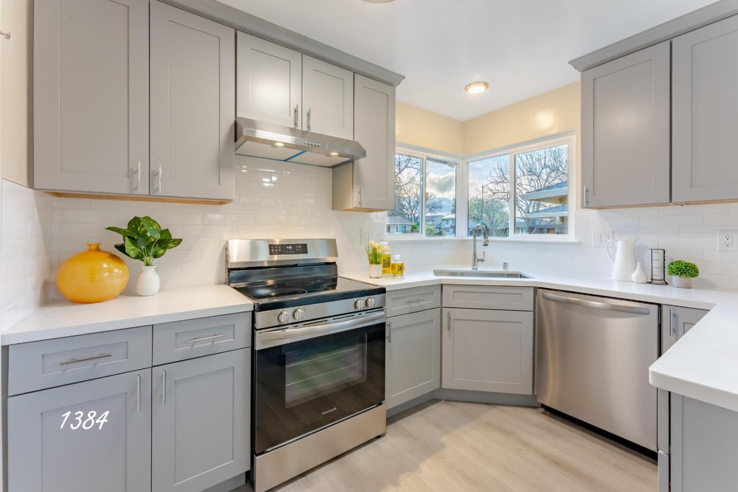 1384 Darryl Drive San Jose, CA 95130 - Photo 25 of 34 a kitchen with stainless steel appliances white cabinets and a stove top oven