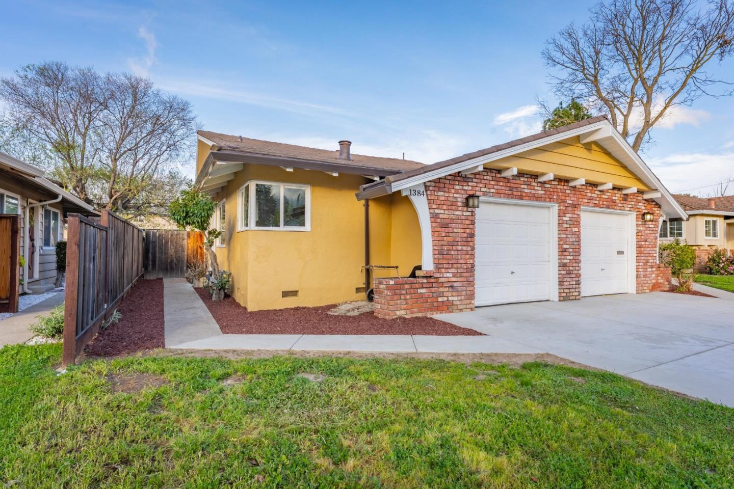 1384 Darryl Drive San Jose, CA 95130 - Photo 3 of 34 a view of backyard of house with wooden fence and a large tree