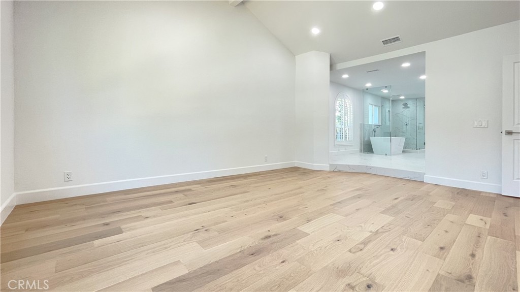 45 Westport Irvine, CA 92620 - Photo 31 of 45 an empty room with wooden floor and mirror