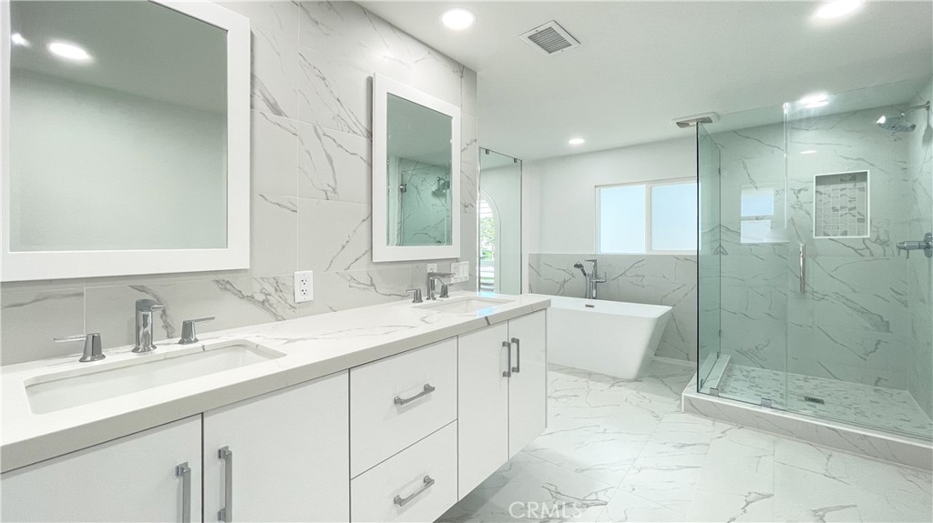 45 Westport Irvine, CA 92620 - Photo 35 of 45 a bathroom with a shower sink double and mirror