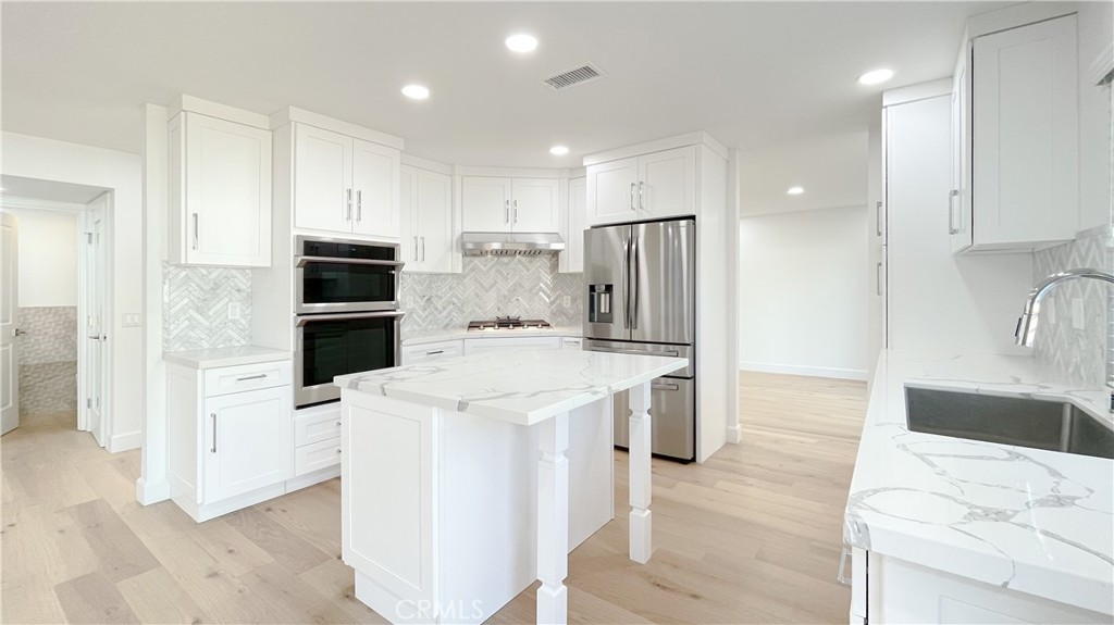 45 Westport Irvine, CA 92620 - Photo 10 of 45 a kitchen with stainless steel appliances kitchen island sink refrigerator and cabinets