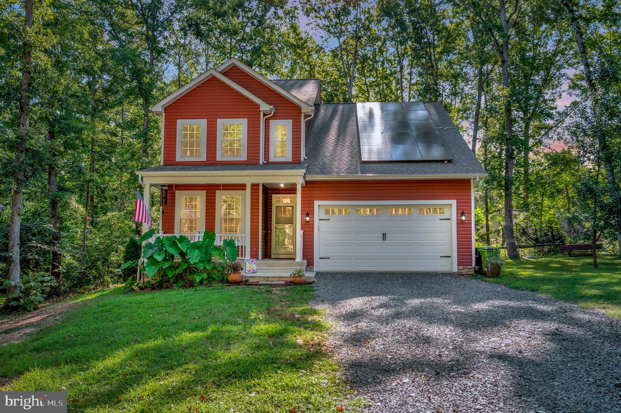 112 Butler Circle Locust Grove, VA 22508 - Photo 1 of 57 a front view of a house with a yard and garage