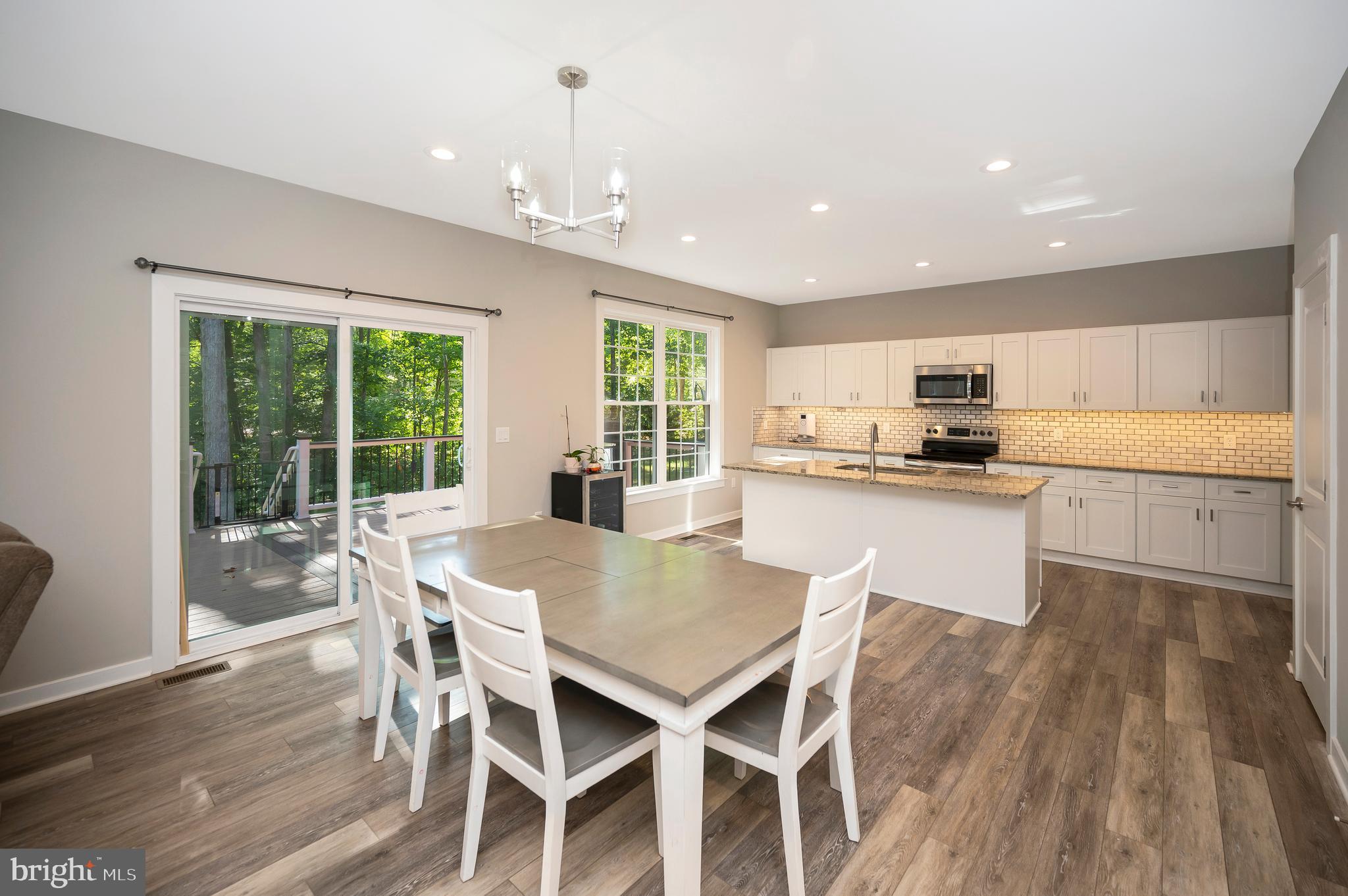 112 Butler Circle Locust Grove, VA 22508 - Photo 12 of 57 a kitchen with kitchen island granite countertop wooden floors and white appliances