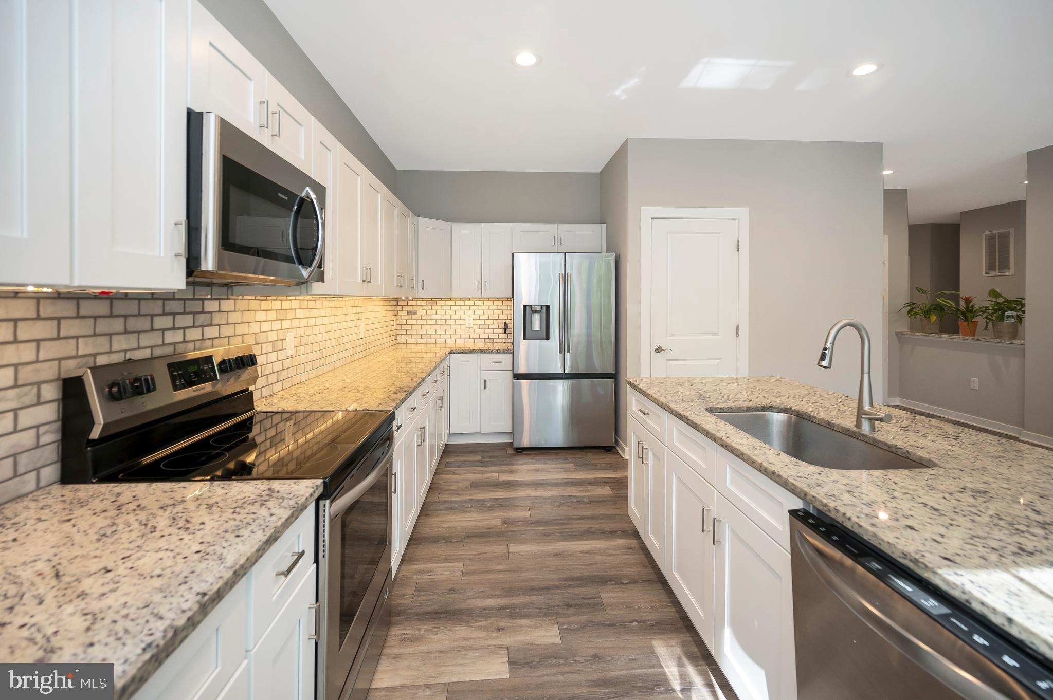112 Butler Circle Locust Grove, VA 22508 - Photo 16 of 57 a kitchen with stainless steel appliances granite countertop a sink stove and refrigerator