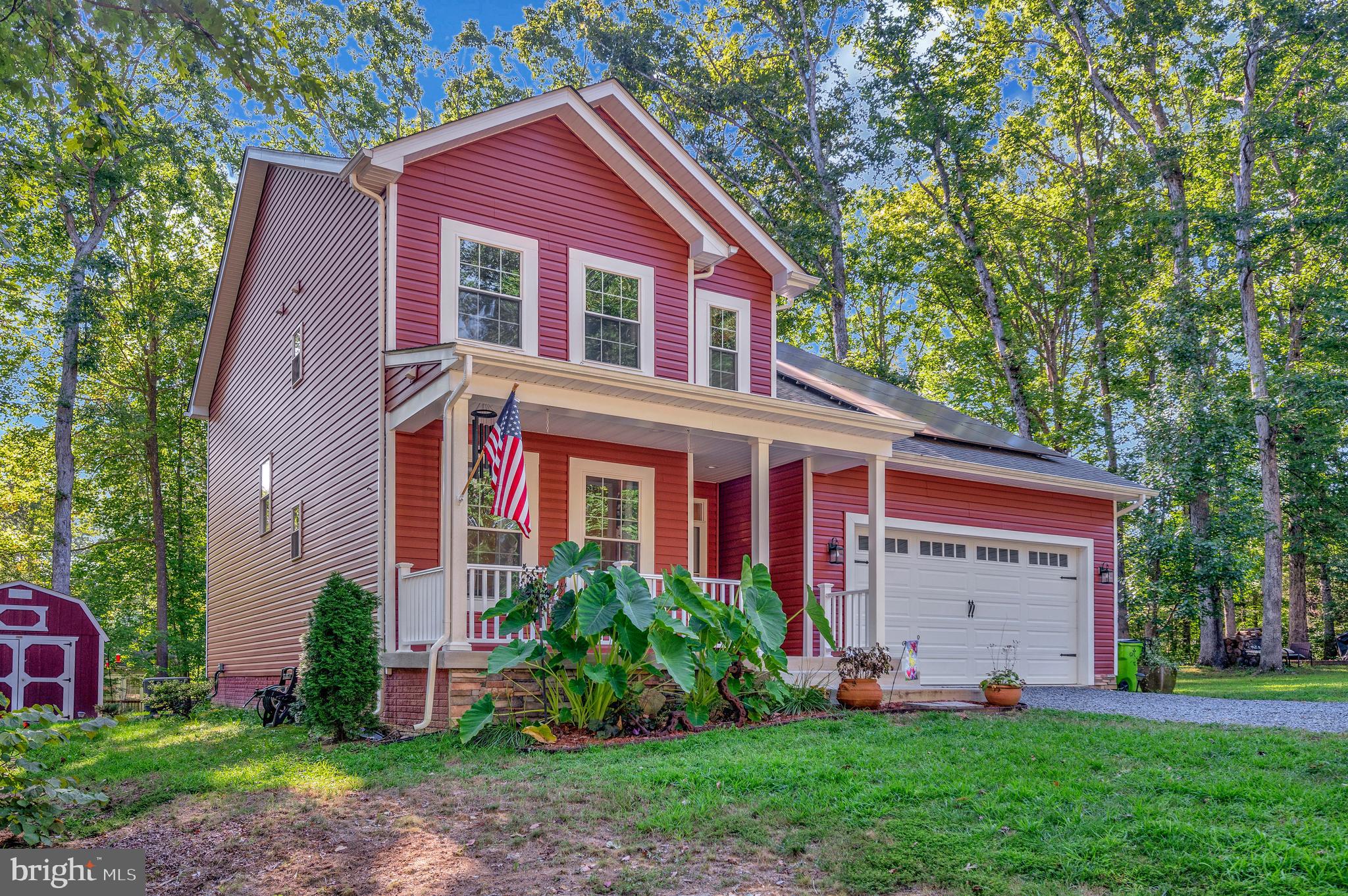 112 Butler Circle Locust Grove, VA 22508 - Photo 2 of 57 a view of a yard in front of a house with plants and large tree