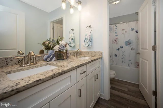 an empty room with window and ceiling fan