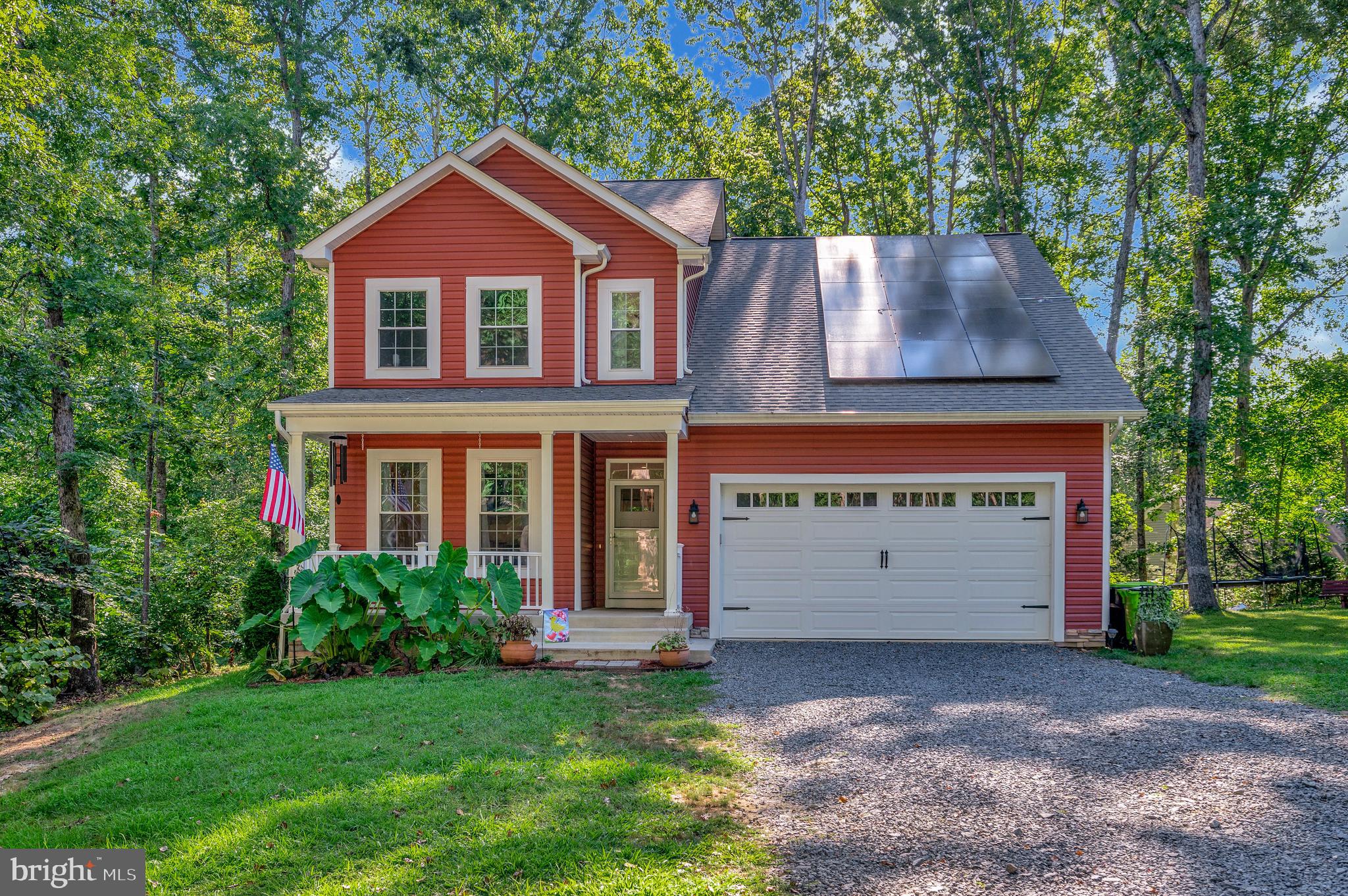 112 Butler Circle Locust Grove, VA 22508 - Photo 55 of 57 a front view of a house with a garden and garage