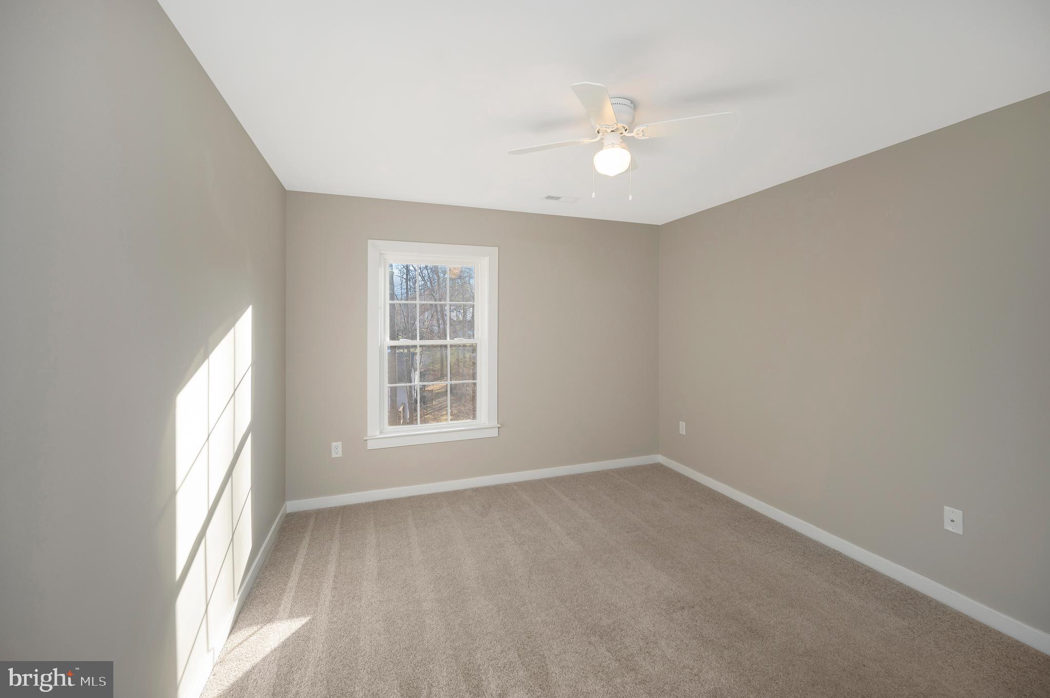 112 Butler Circle Locust Grove, VA 22508 - Photo 57 of 57 an empty room with windows and chandelier fan