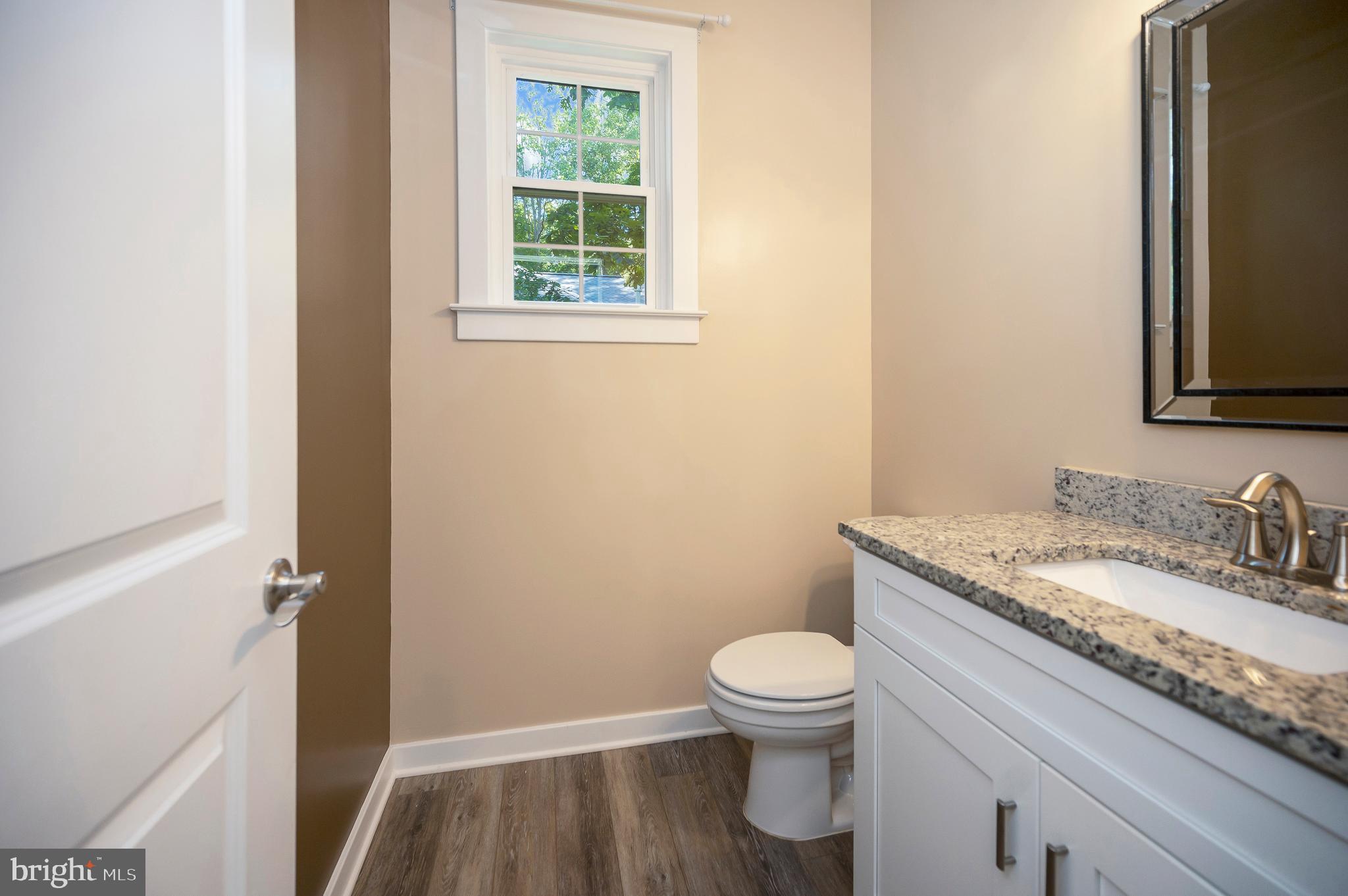 112 Butler Circle Locust Grove, VA 22508 - Photo 7 of 57 a bathroom with a granite countertop toilet sink and mirror