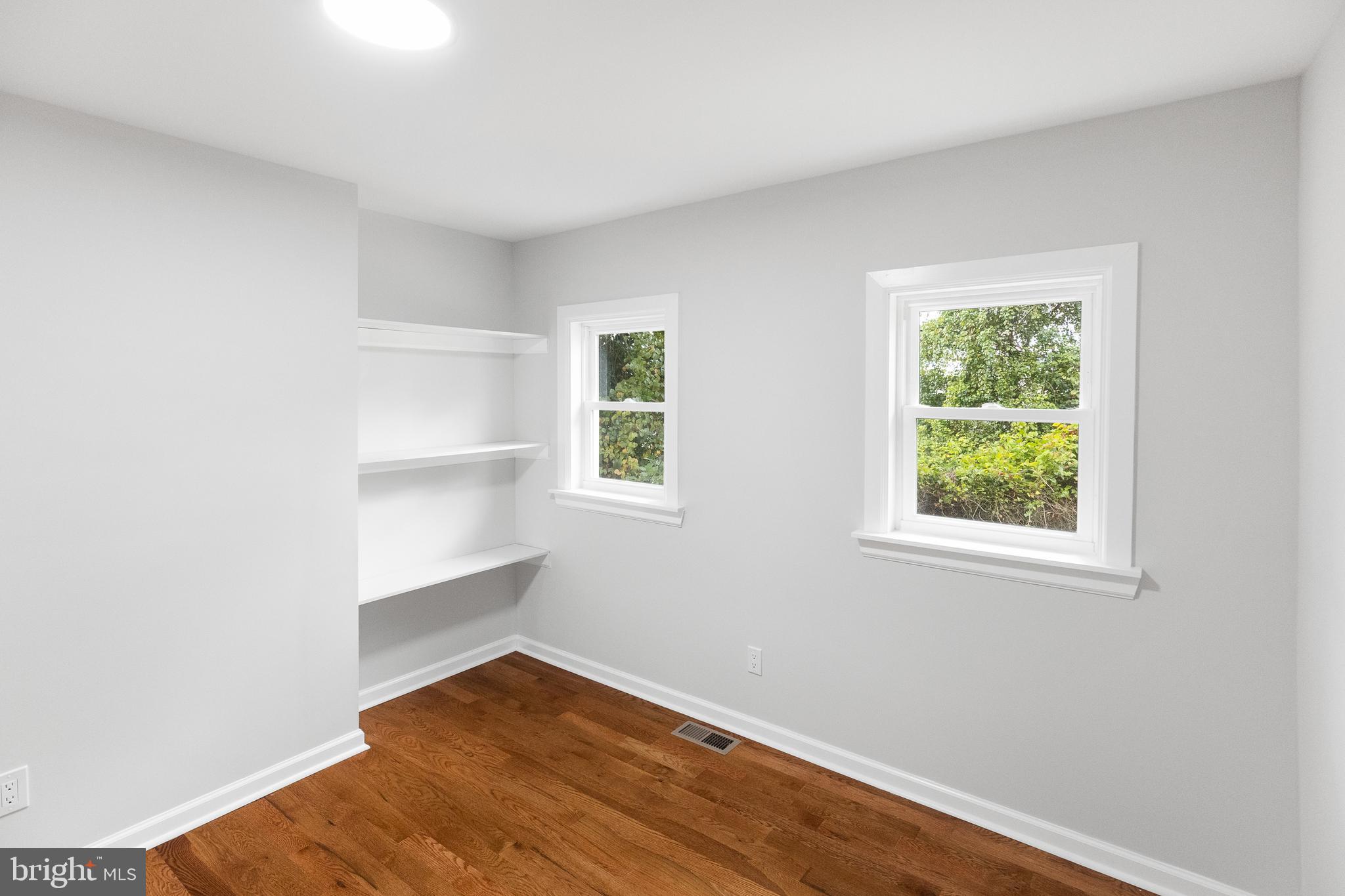 1528 Hunt Avenue Landover, MD 20785 - Photo 11 of 27 an empty room with wooden floor and windows