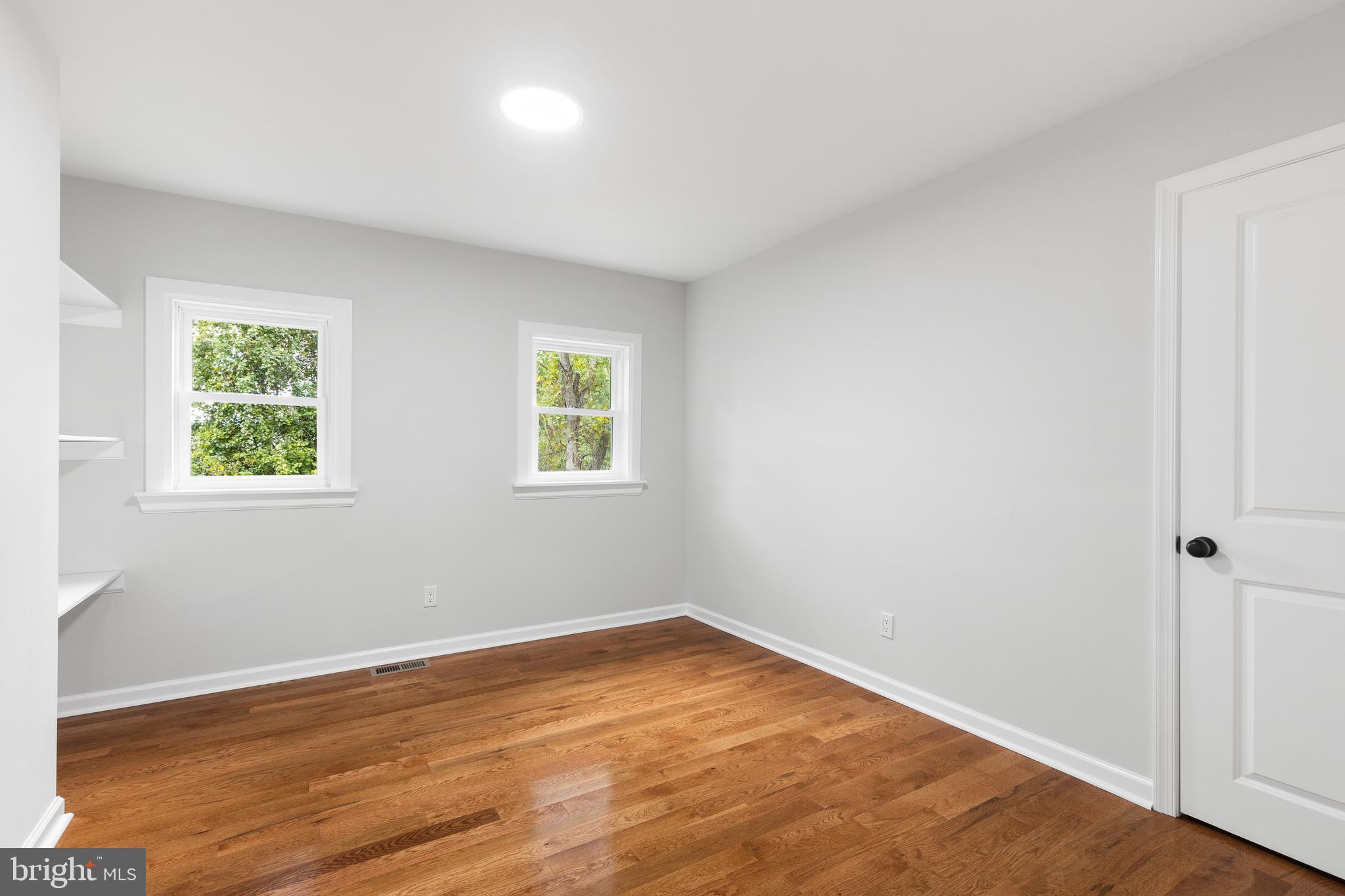 1528 Hunt Avenue Landover, MD 20785 - Photo 12 of 27 an empty room with wooden floor and windows