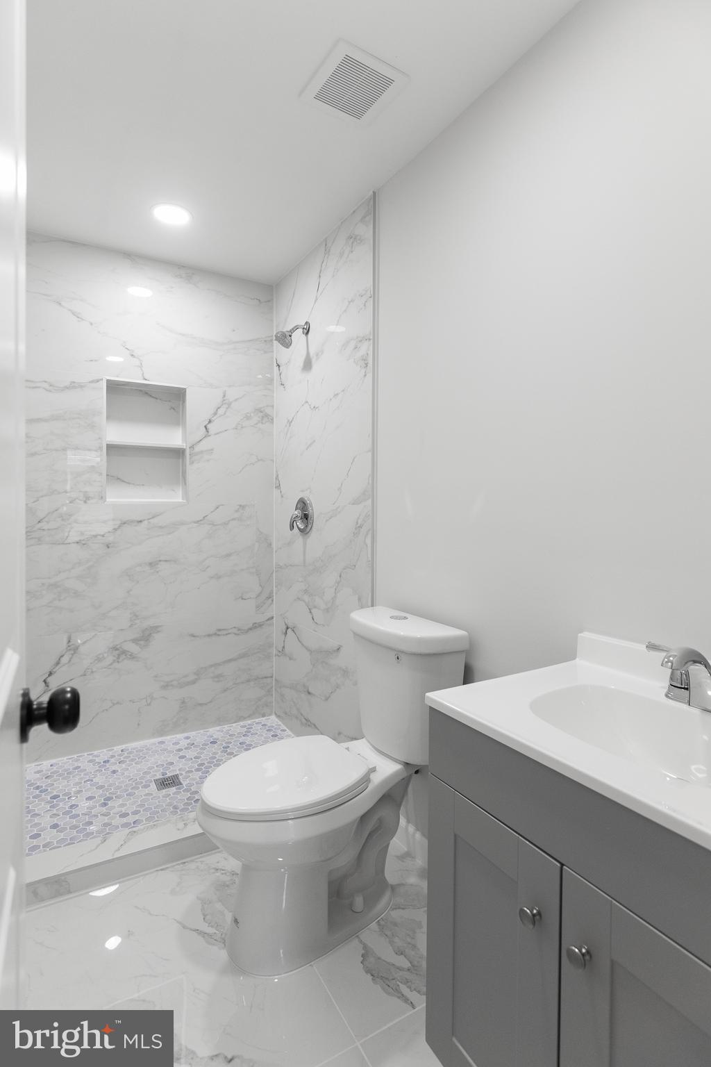 1528 Hunt Avenue Landover, MD 20785 - Photo 14 of 27 a bathroom with a sink a toilet and shower