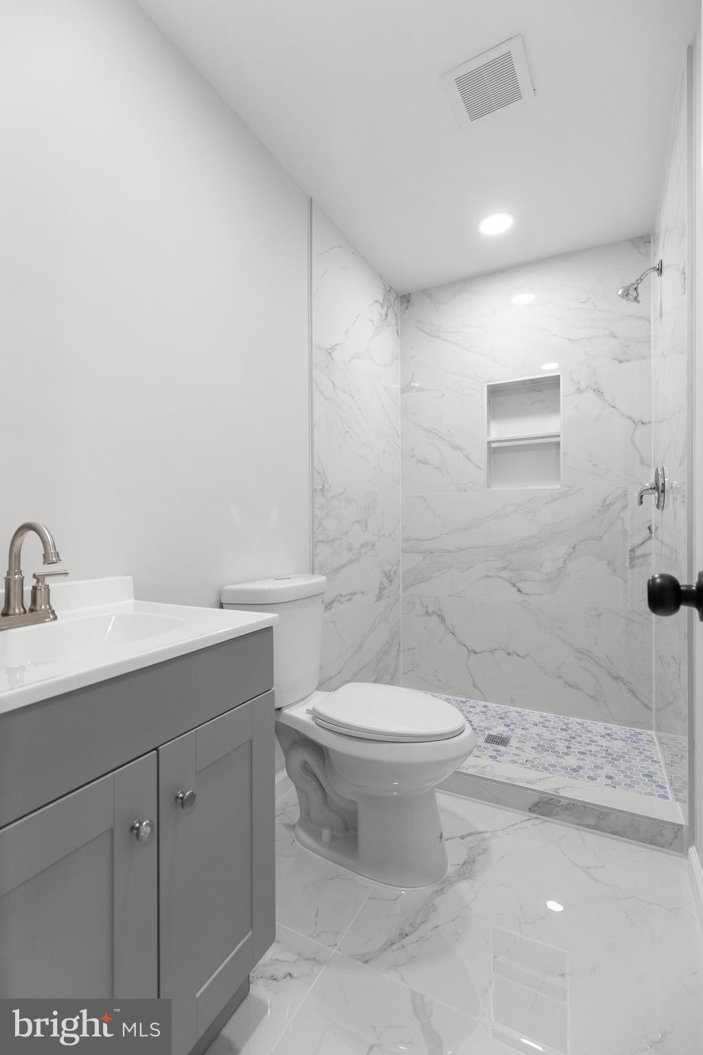 1528 Hunt Avenue Landover, MD 20785 - Photo 15 of 27 a bathroom with a sink a toilet and mirror