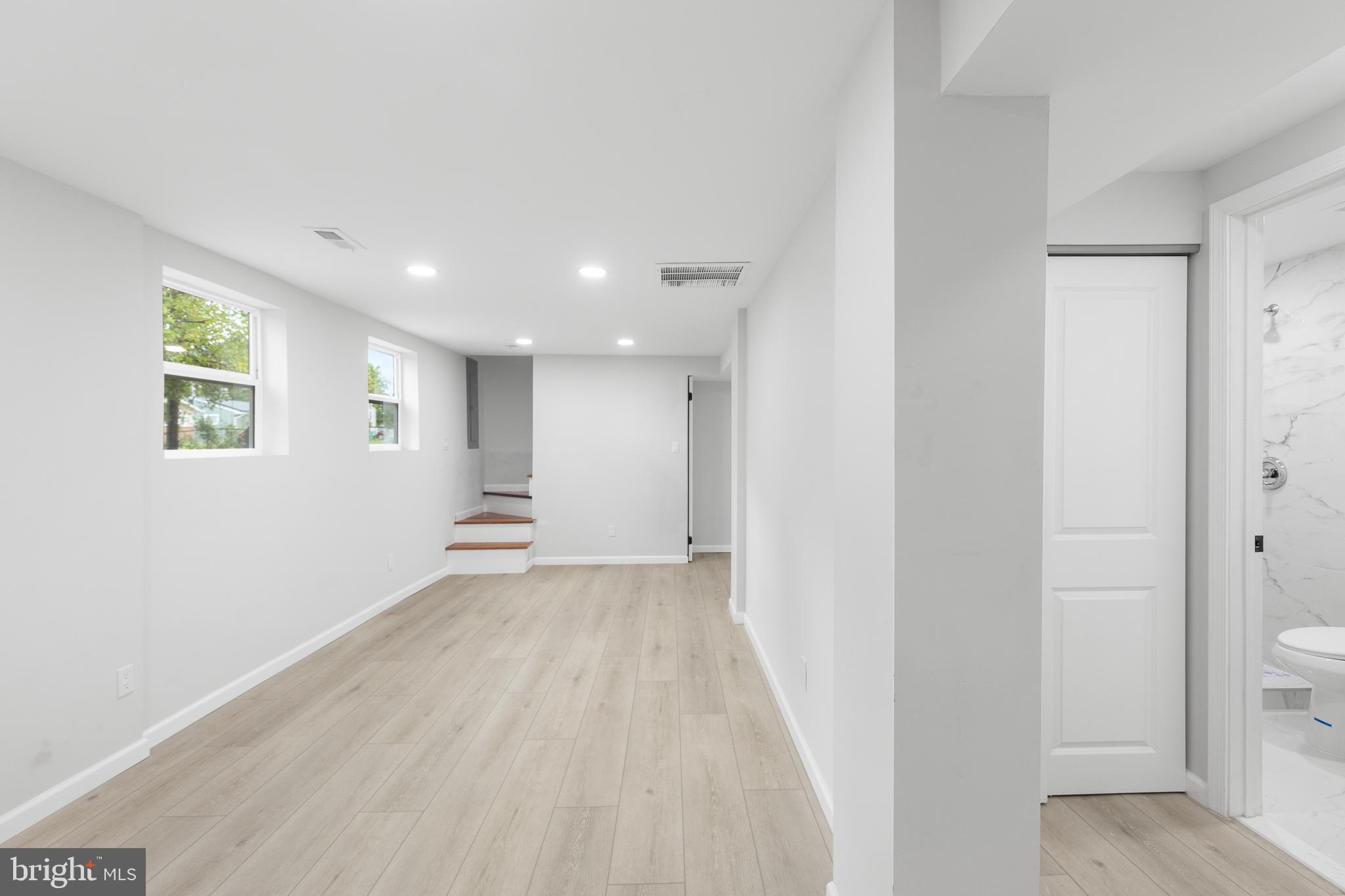 1528 Hunt Avenue Landover, MD 20785 - Photo 19 of 27 a view of an empty room with wooden floor and a window
