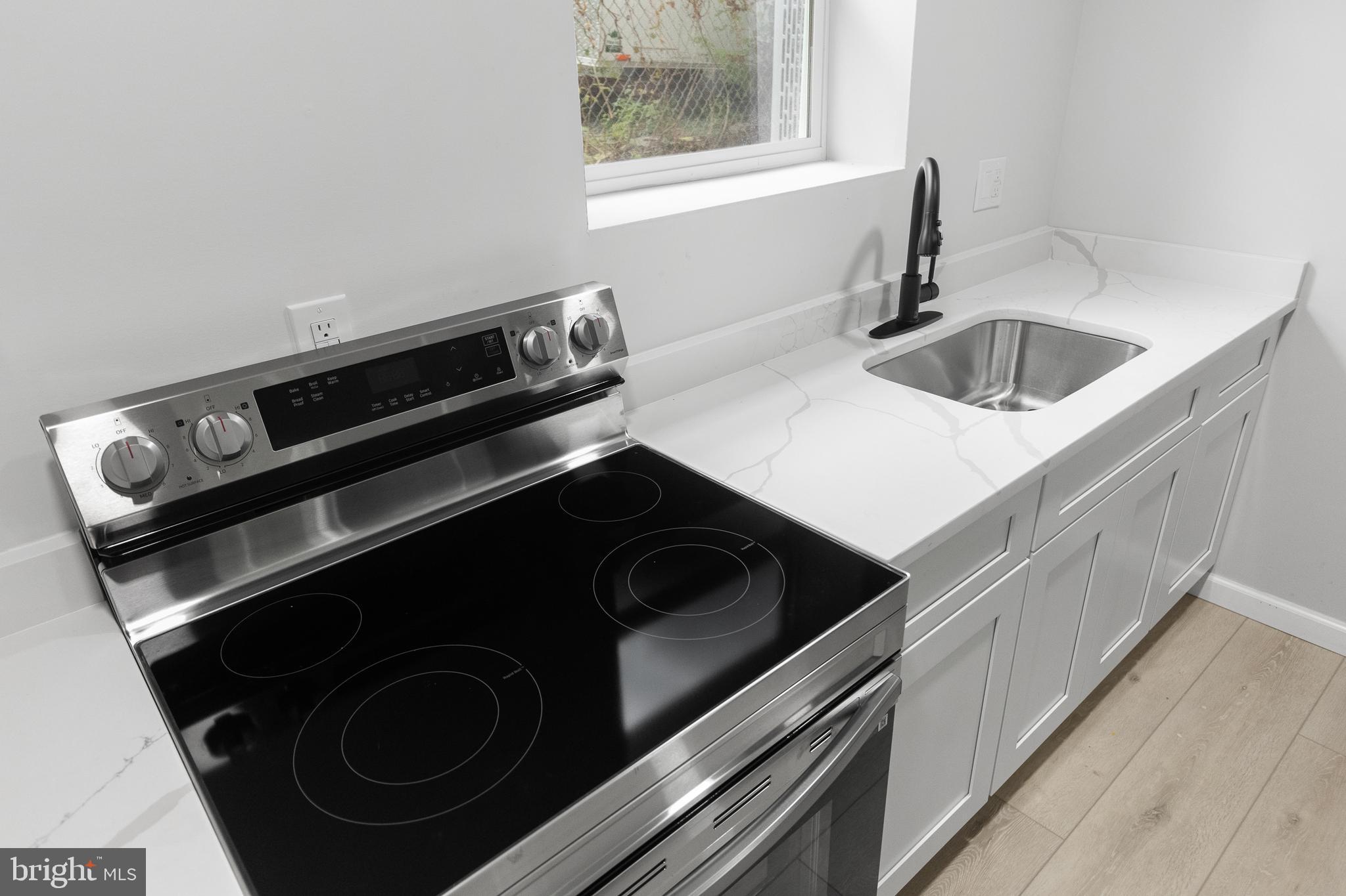 1528 Hunt Avenue Landover, MD 20785 - Photo 20 of 27 a close view of a sink and a stove in a kitchen