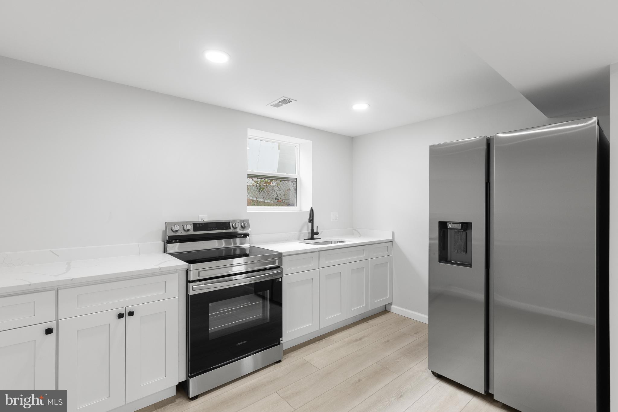 1528 Hunt Avenue Landover, MD 20785 - Photo 21 of 27 a kitchen with stainless steel appliances granite countertop a refrigerator and a stove top oven