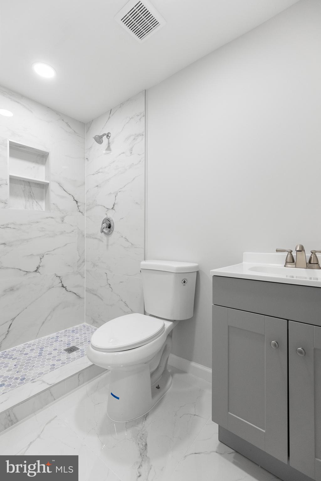 1528 Hunt Avenue Landover, MD 20785 - Photo 25 of 27 a bathroom with a sink a toilet and shower