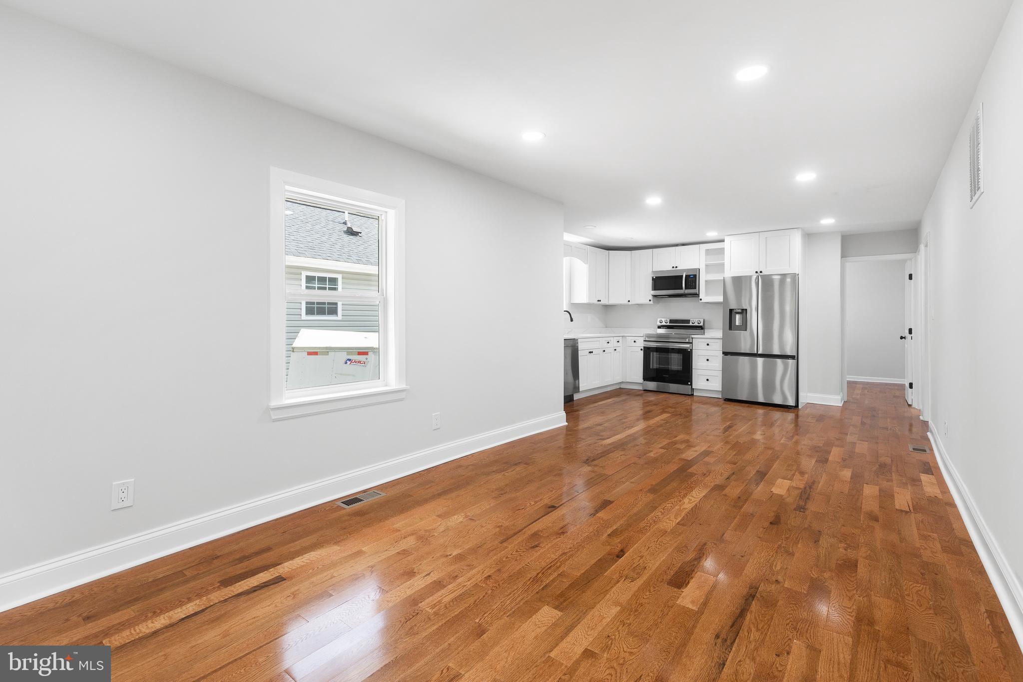 1528 Hunt Avenue Landover, MD 20785 - Photo 4 of 27 a view of empty room with kitchen and window