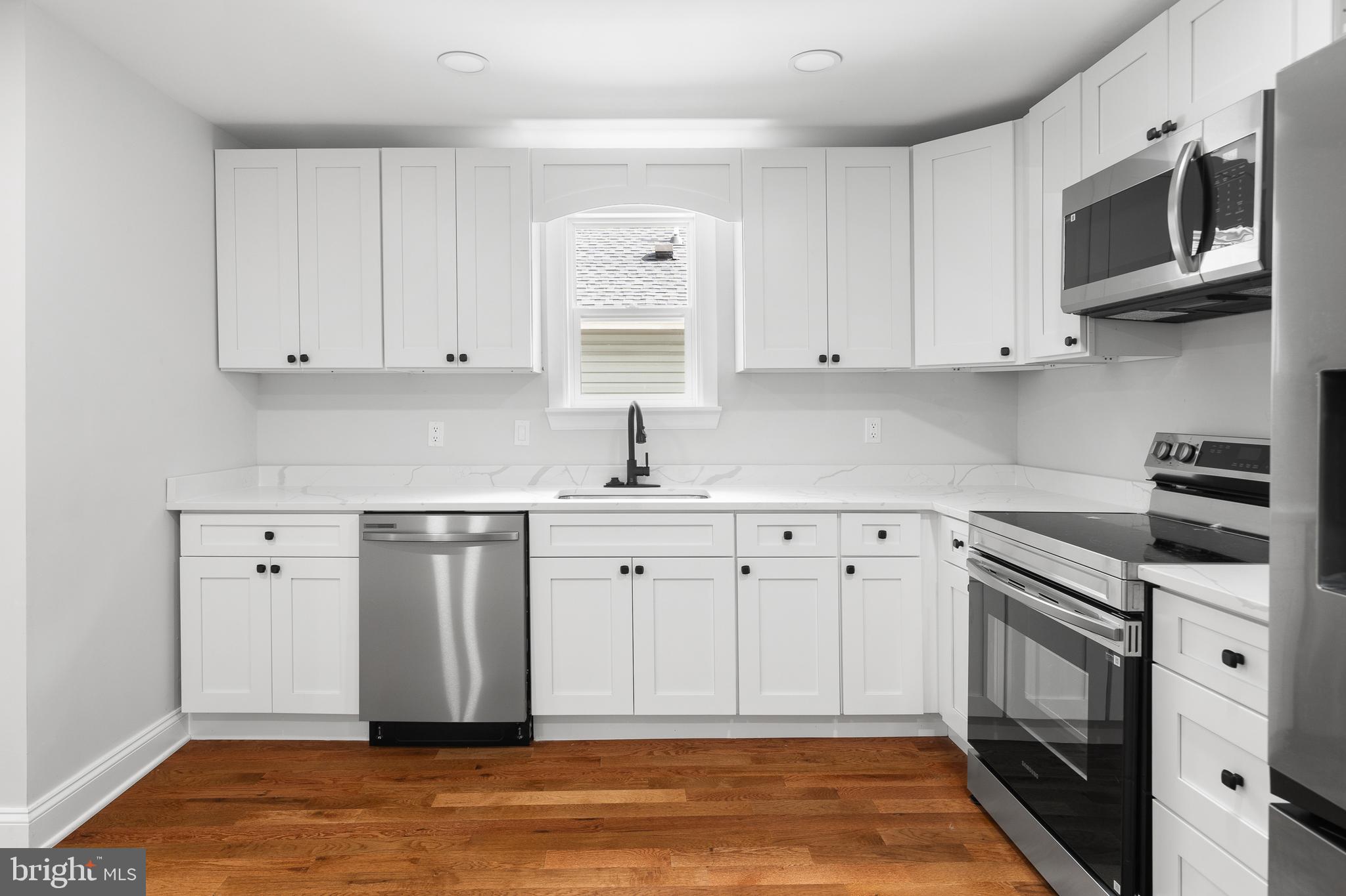 1528 Hunt Avenue Landover, MD 20785 - Photo 5 of 27 a kitchen with stainless steel appliances granite countertop a sink stove and microwave