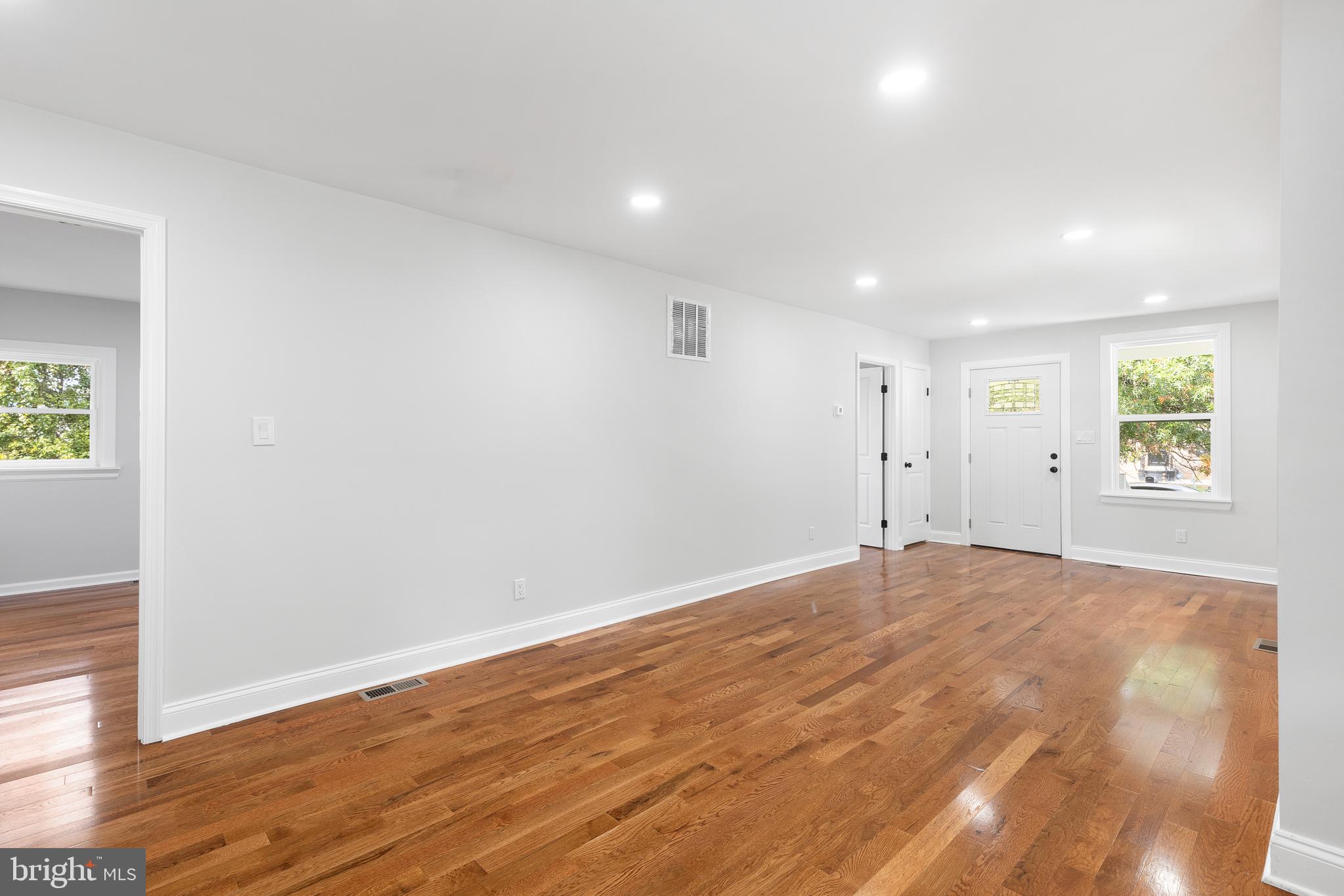 1528 Hunt Avenue Landover, MD 20785 - Photo 7 of 27 an empty room with wooden floor and windows