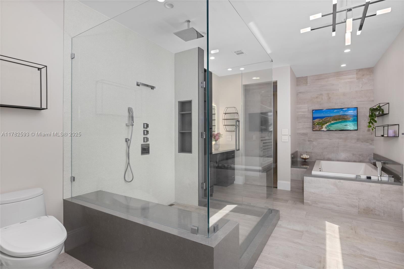 10972 Pine Lodge Trail Davie, FL 33328 - Photo 11 of 21 a spacious bathroom with a granite countertop sink a toilet a mirror and shower