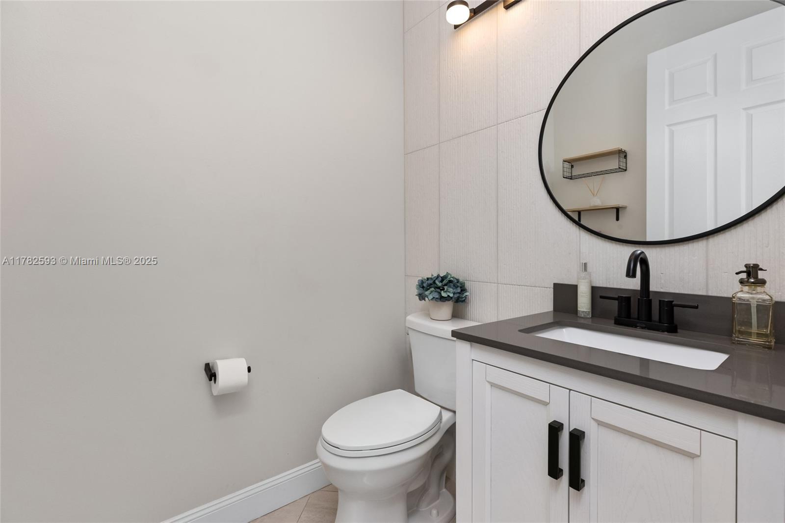 10972 Pine Lodge Trail Davie, FL 33328 - Photo 17 of 21 a bathroom with a sink and a mirror