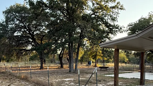 a view of a house with a backyard and porch