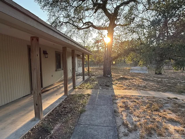 a view of a pathway of a house with a yard