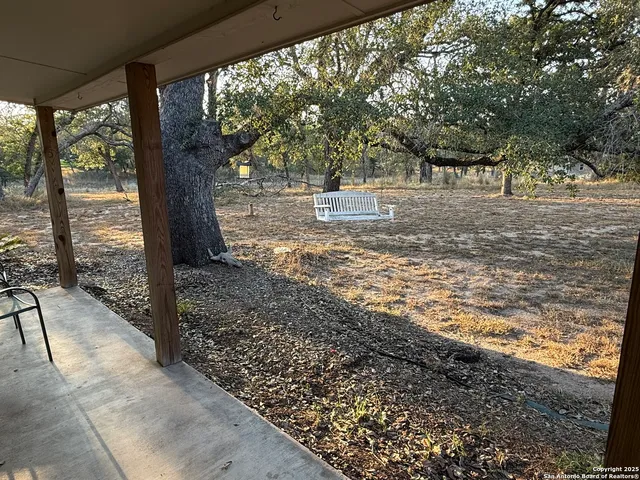 a view of a yard with wooden floor