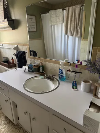 a bathroom with a double vanity sink and a mirror