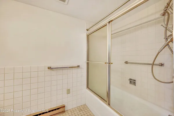 a bathroom with a toilet and shower