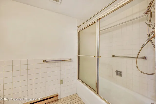 a bathroom with a toilet and shower