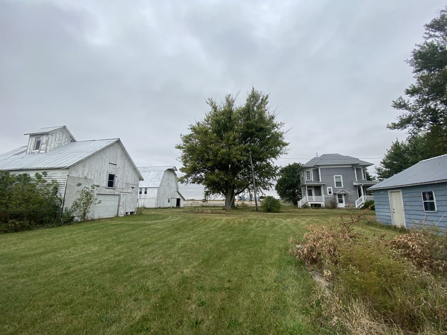 4684 Perry Road Malta, IL 60150 - Photo 26 of 36 a big house with a big yard and large trees