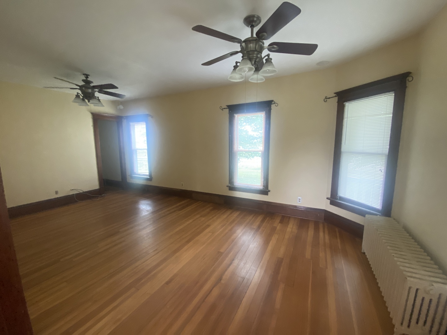 4684 Perry Road Malta, IL 60150 - Photo 9 of 36 a view of an empty room with a window and wooden floor