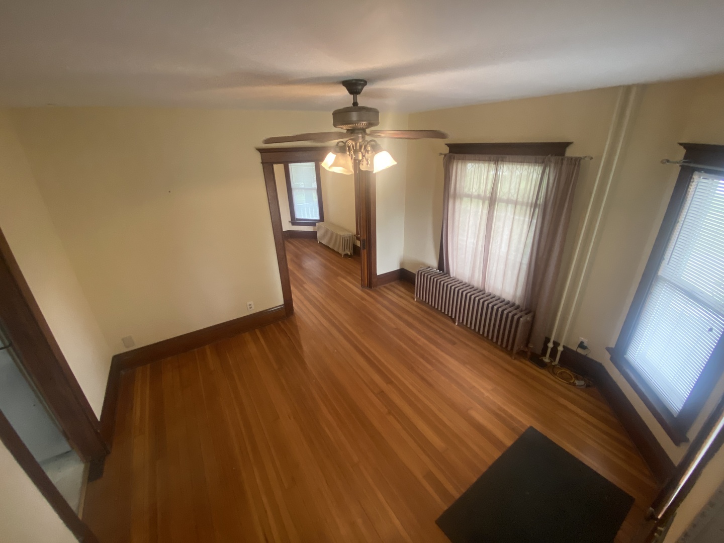 4684 Perry Road Malta, IL 60150 - Photo 10 of 36 a view of an empty room with wooden floor and a window