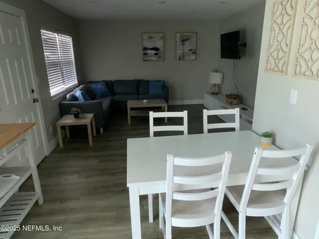 a dining room with furniture and wooden floor